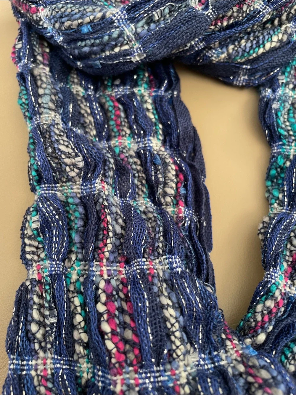 Infinity scarf new in package. Colors blue, red teal and silver. Great accent to